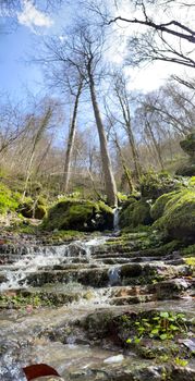 Beautiful landscape of mountain stream flowing down stone steps. Mountain waterway flowing down natural stairs in picturesque place