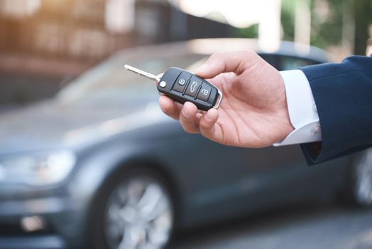 Dreams Come True. Young man holds the keys to a new car