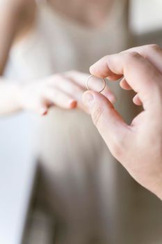 the groom puts the ring on the bride's finger close-up. wedding