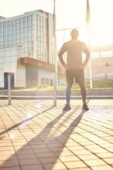 Enjoying healthy lifestyle. Full length portrait of sporty african man in sportswear enjoying sunny morning while doing workout outside. Healthy lifestyle. Sport motivation concept. Fitness concept.