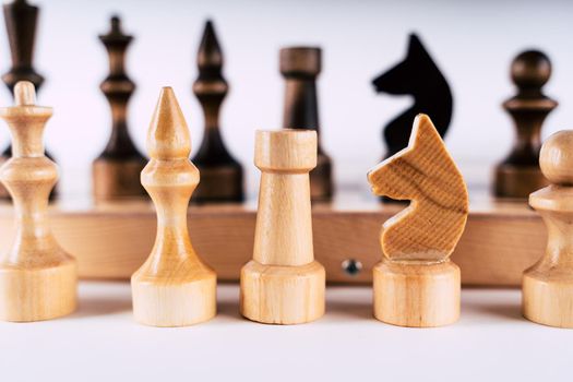 Close-up of chess on a gray background. Wooden chess pieces. Concept: the Board game and the intellectual activities.