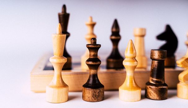 Close-up of chess on a gray background. Wooden chess pieces. Concept: the Board game and the intellectual activities.