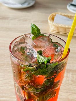 Fresh summer cocktail with strawberry and ice cubes