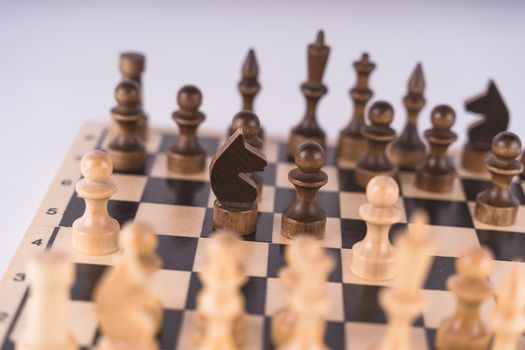 Close-up of chess on a gray background. Wooden chess pieces.