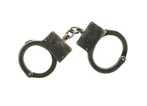 Old metal handcuffs isolated on white background with clipping path