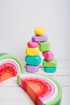 Wooden cubes with different faces for the development of coordination and balancing. Bright toys for children made of natural wood. Wooden rainbows in the form of a watermelon. Zero waste.
