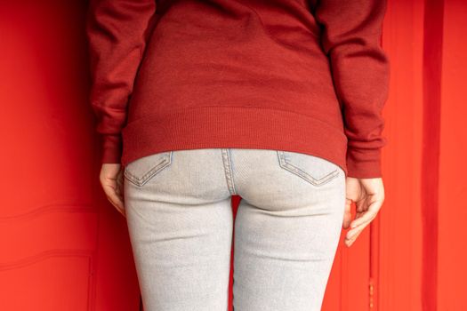 Close up of female buttocks in jeans. Rear view on buttocks of unrecognizable woman