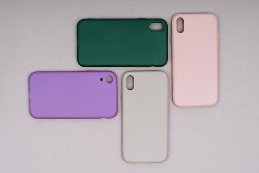 Four silicone smartphone cases. Phone cases are pink, purple, green and gray.