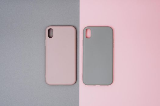 Two silicone protective cases for the smartphone. Grey and pink phone cases.