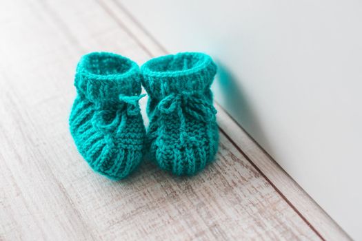 Mint knitted booties for a child. Knitted socks for the baby.