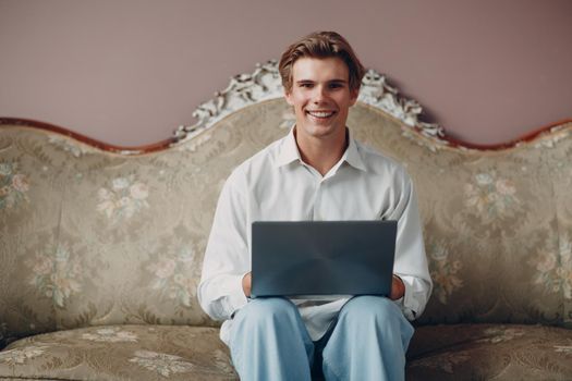 Portrait european young man sitting with laptop during video call web conference. Work in home office concept.