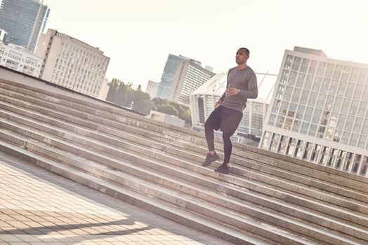 Sport in my life. Full length portrait of athletic african man in sportswear jogging down stairs in the urban environment on a sunny warm day. Cardio training. Urban workout. Sport motivation concept. Fitness concept