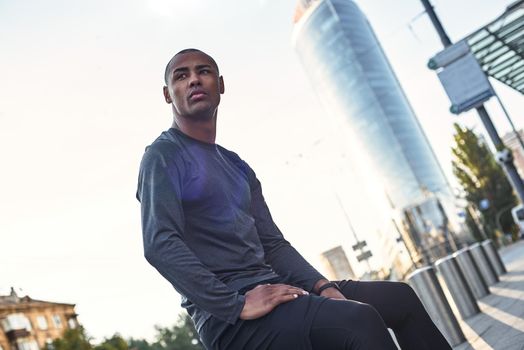 Fitness is the way of life. Close up portrait of thoughtful young african male resting during urban outdoor workout. Lifestyle concept. Cardio training. Morning workout. Sport motivation concept. Fitness