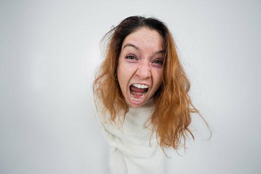 Close-up portrait of insane woman in straitjacket on white background