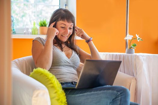 emotional young woman looks into a laptop. beautiful young . blogger painfully comes up with content for public page