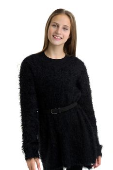 Happy teenage girl in trendy black outfit. Portrait of a beautiful girl with long straight hair in a black dress with stockings on a white background in the studio. Close-up