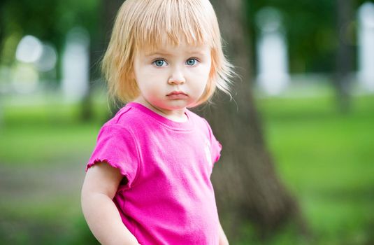 Portrait of two-year child at playground area in summer