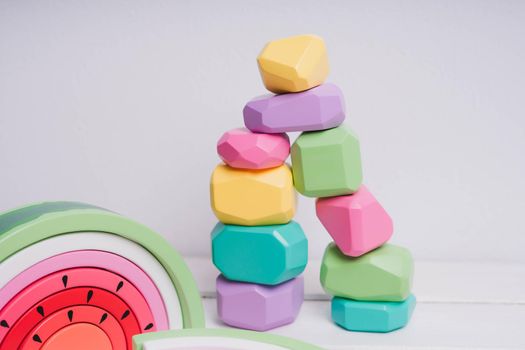 Wooden cubes with different faces for the development of coordination and balancing. Bright toys for children made of natural wood. Wooden rainbows in the form of a watermelon. Zero waste.