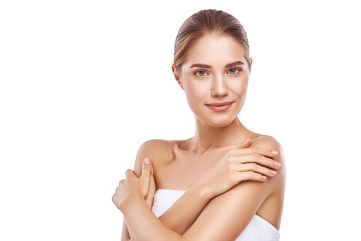 Beautiful womans face and hands, close-up studio photo on white background. Light hair, grey eyes. She is wearing white towel