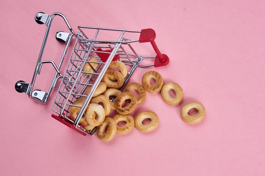 small shopping carts supermarket shopping pink background. High quality photo