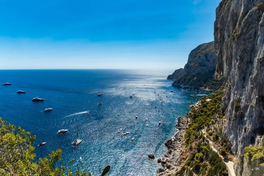 Beautiful panorama of small bay full of small ships and boats next to Capri island 