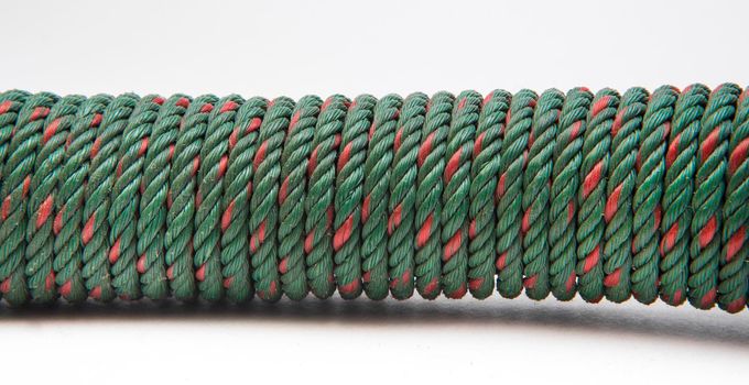 Green nylon rope on a white ground