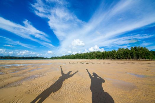 Shadow Couple on the Beach Summer Holiday Concept