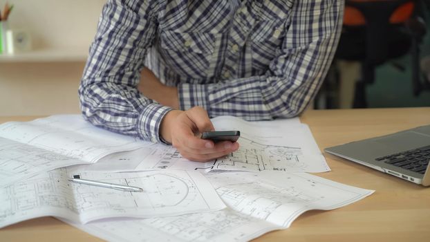 Close up worker in creative agency holding smartphone