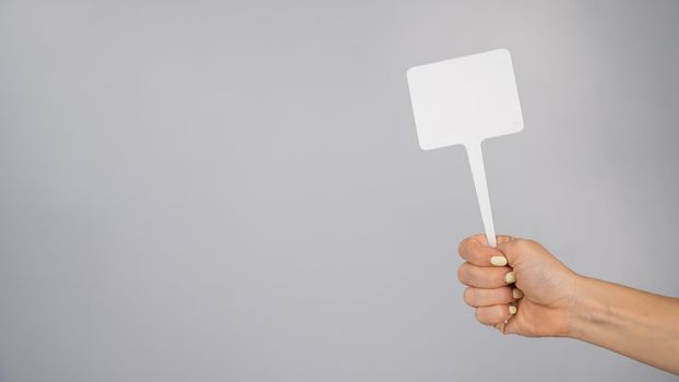 Woman holding blank sign on white background. Copy space