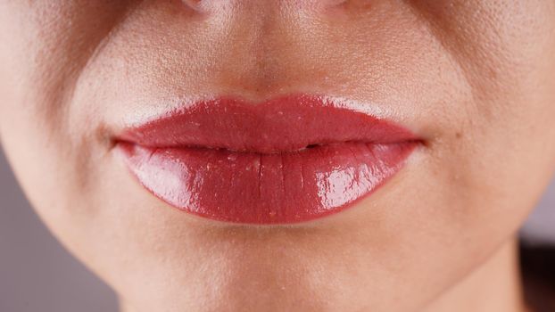 Female lips after permanent tattooing close-up