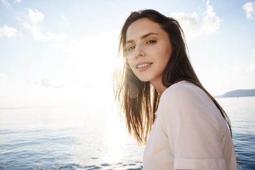 Portrait of young beautiful woman standing on boat against sea backgorund, close up
