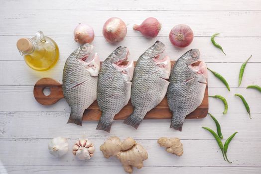 raw fresh sea fish on plate on table