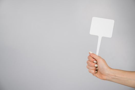 Woman holding blank sign on white background. Copy space