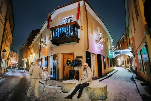 A family walks around the New Year's city of Vilnius.Lithuania.