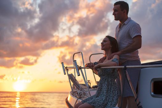 Loving couple spending time on a yacht at the open sea