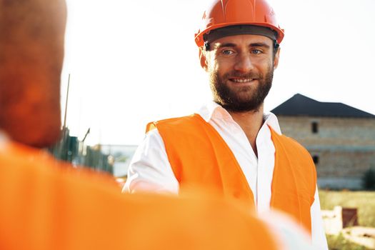 Portrait of young construction engineer wearing hardhat, close up