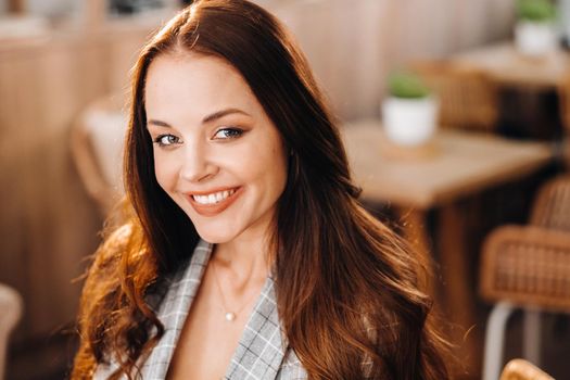 portrait of an Attractive young woman who is sitting in a cafe. Cafe urban lifestyle. Random portrait.