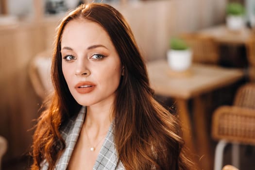 portrait of an Attractive young woman who is sitting in a cafe. Cafe urban lifestyle. Random portrait.