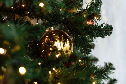 Gold festive ball on the Christmas tree