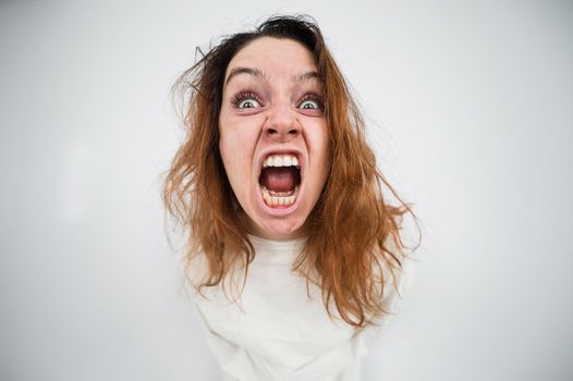 Close-up portrait of insane woman in straitjacket on white background