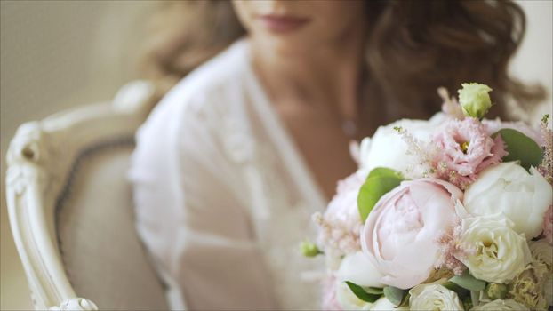 Bride and groom hug each other. Bride with bouquet of the bride. Beautiful bouquet of the bride.