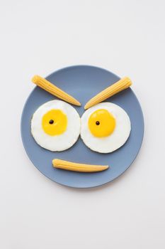 cheerful breakfast, two funny eggs on a plate