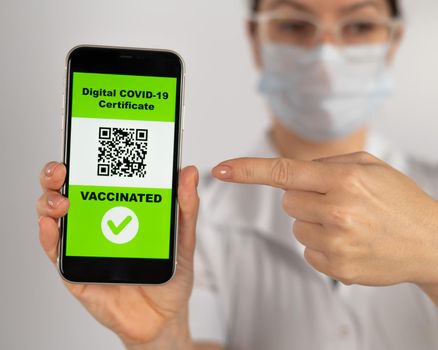 The doctor recommends vaccination and holds a smartphone with a QR code