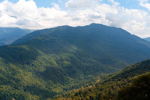 Scenic green mountains and beautiful sky clouds for a background