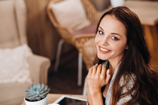 portrait of an Attractive young woman who is sitting in a cafe. Cafe urban lifestyle. Random portrait.