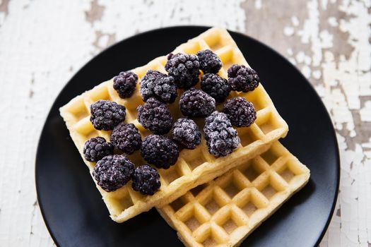 Delicious and beautiful Belgian waffles with blackberries.