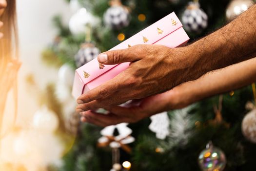 Close up photo of male hands holding Christmas gift box