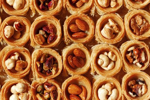 Background of assorted traditional arabic dessert Baklava with honey and nuts