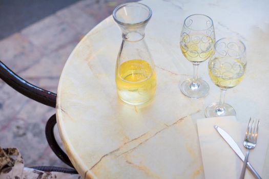 White wine in liter bottle on a table in a cafe