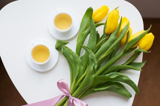 beautiful yellow tulips, two cups of green tea, spring